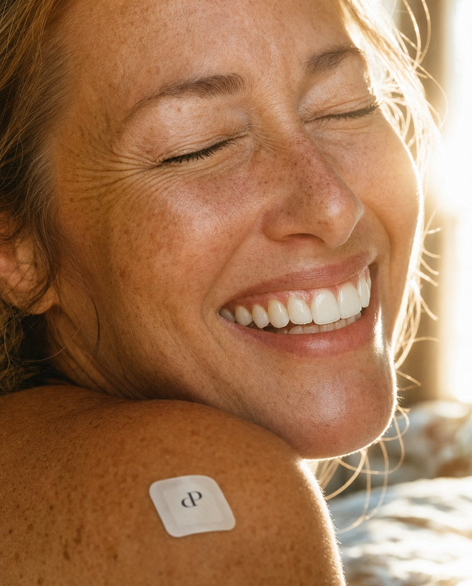 Woman laughing in the morning sun wearing a Night Burn patch on her shoulder